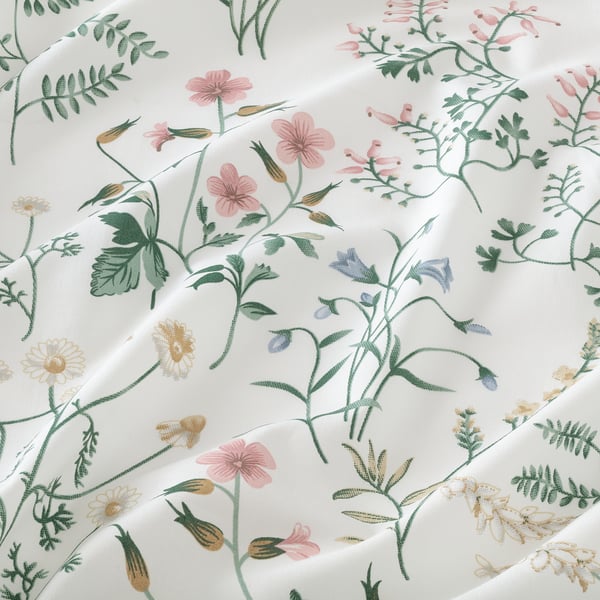 High-quality cotton sheet set with vibrant summer meadow floral print, soft and vivid colours.