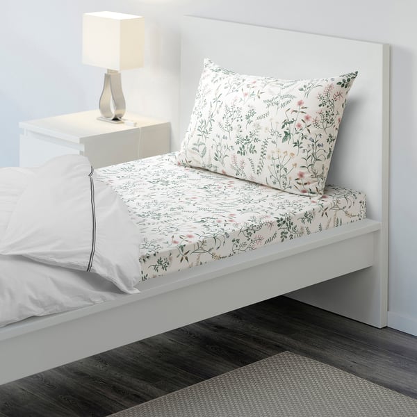 White floral bedding, minimalist room.
