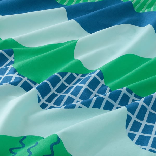 Soft, crisp bed sheets with blue and green waves, made of 100% cotton.