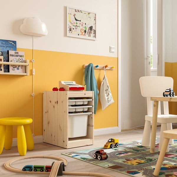 Childrens playroom with yellow TROFAST storage, wooden toys, and bright decor.