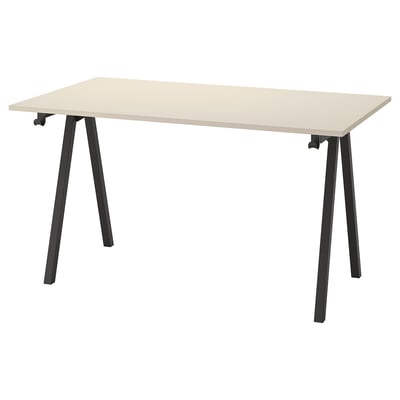 A TROTTEN desk with a beige top and black metal legs.