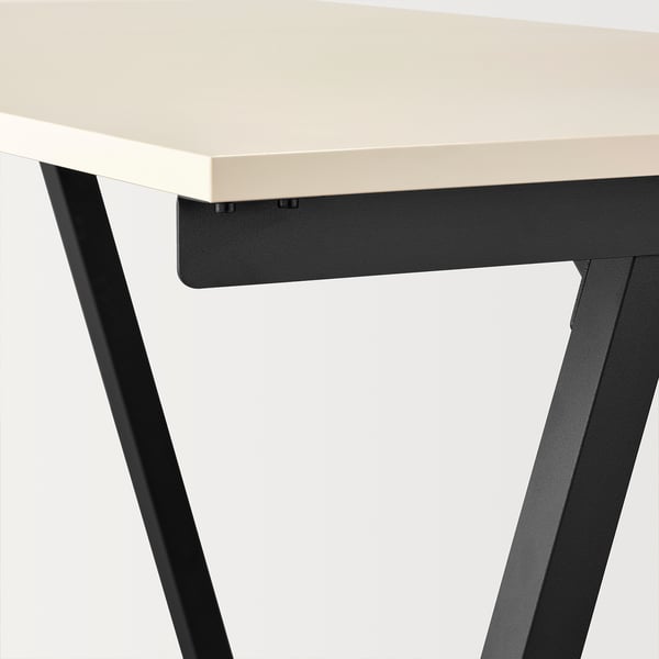 Clean, modern desk with light top, dark metal legs.