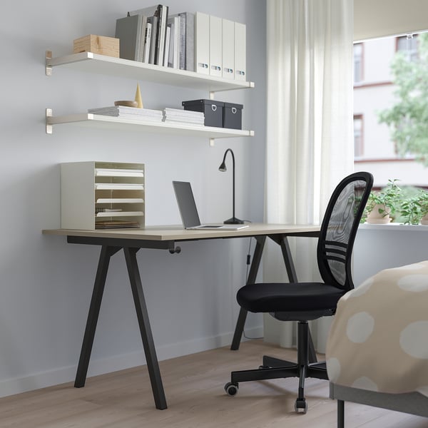 Beige TROTTEN desk with black legs & chair. Fits laptop, files, lamp. Modern minimalist home office.