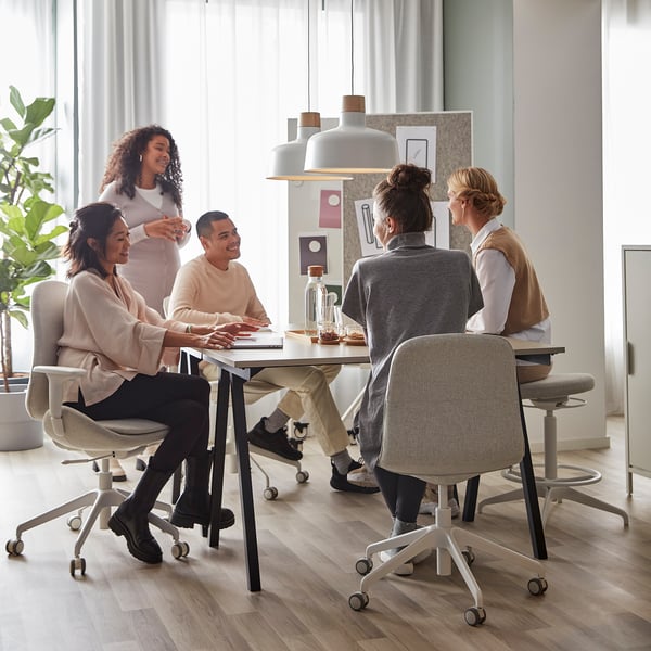 Five people at TROTTEN desks in a bright room, maximised under-space usability.