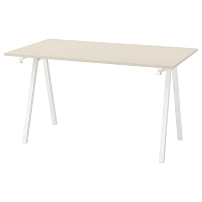 A TROTTEN desk with light beige top and white, a-shaped legs. Its simple and sturdy for various spaces.