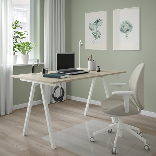 Modern green home office. Light desk, grey chair, plant, laptop, & lamp.