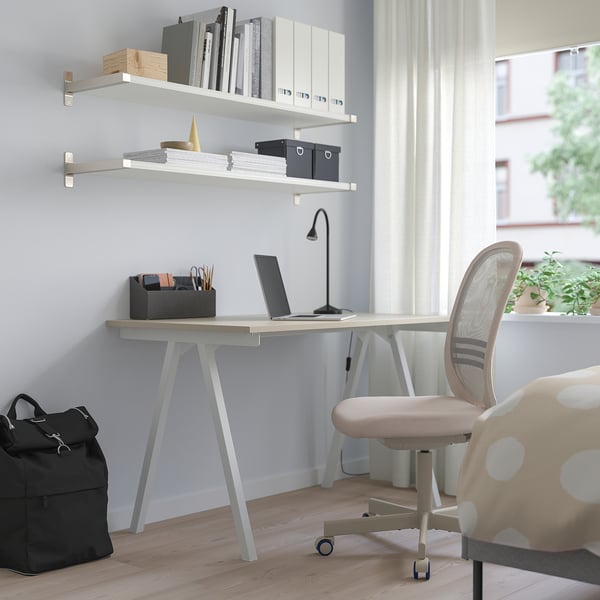 Beige TROTTEN a-shaped desk for small spaces with wooden top and metal legs.