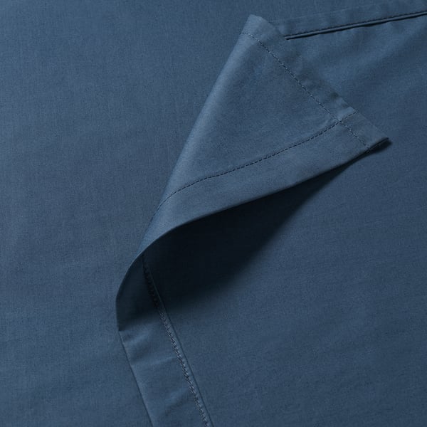Crisp, fitted blue sheets showcasing fine stitching and smooth fabric, highlighting quality and comfort.