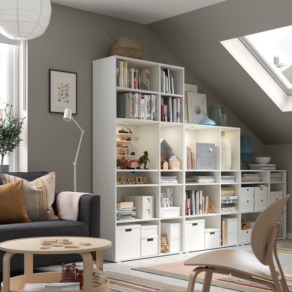 Cosy reading nook with VIHALS storage, books, and toys by a large window.