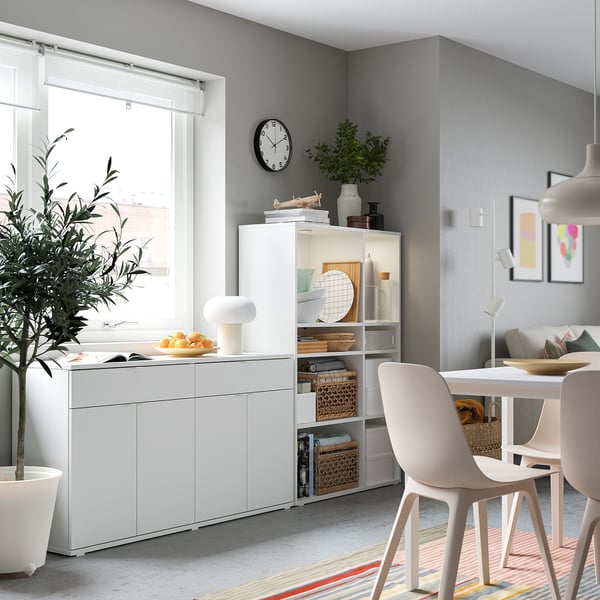 Modern living space with white VIHALS storage units, including shelves and cabinets, adorned with decorative items.