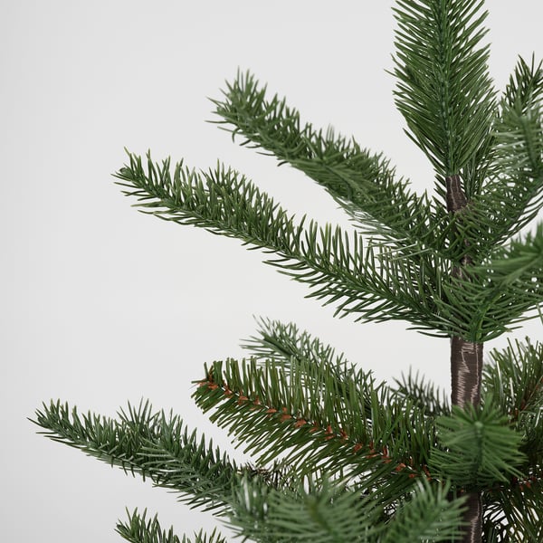 Close-up of VINTERFINT artificial tree with green needles and red berries.