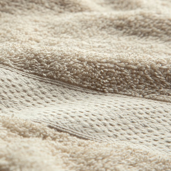Close-up of soft, high-quality cotton towel, showcasing its textured, absorbent weave.