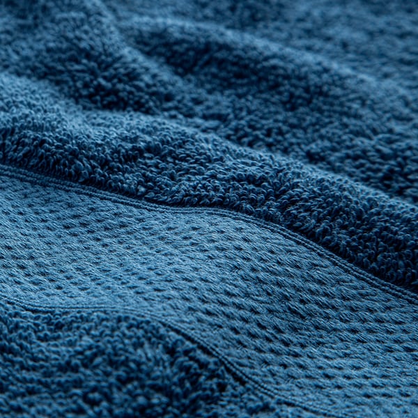 Blue, textured cotton towel close-up, showcasing soft, thick terry weave.