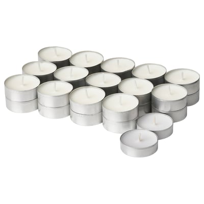 Collection of white ADLAD candles in silver holders, round and stacked in a cluster.