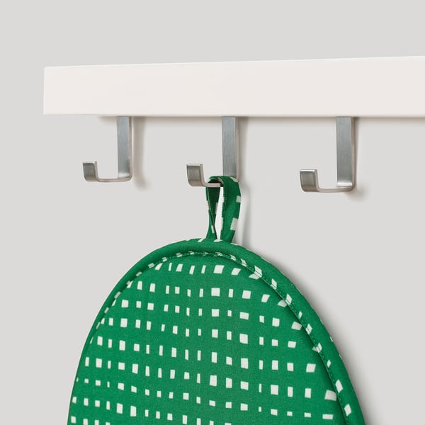 Green & white ÄNGSFRÄKEN chair pad on shelf, eco-friendly, anti-slip, easy storage, vibrant seating.