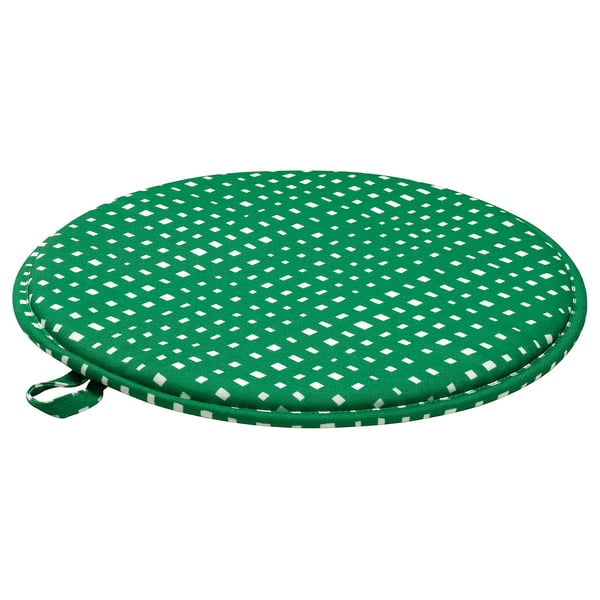 A round, green recycled polyester chair pad with a white chequered pattern, designed for comfortable seating.