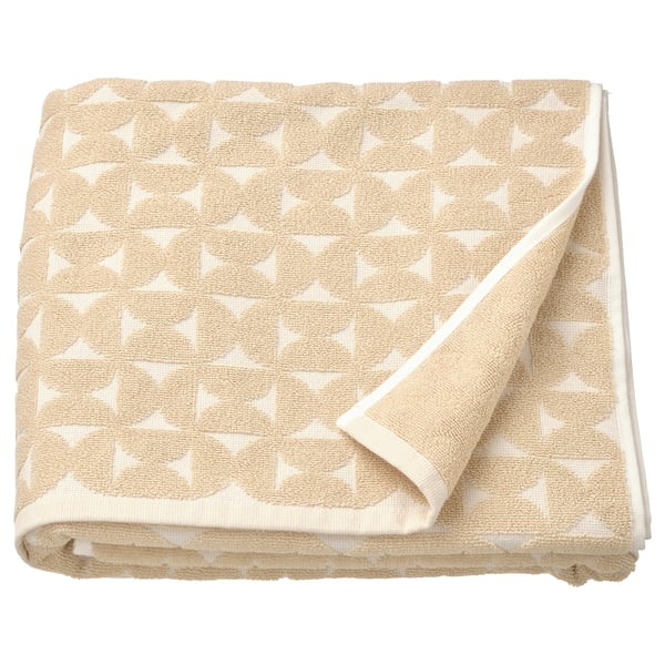 Beige towel with white star pattern, folded neatly.