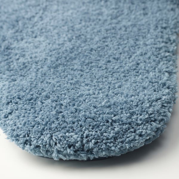 Blue, plush bath mat with soft, dense microfiber texture for comfort and absorption.