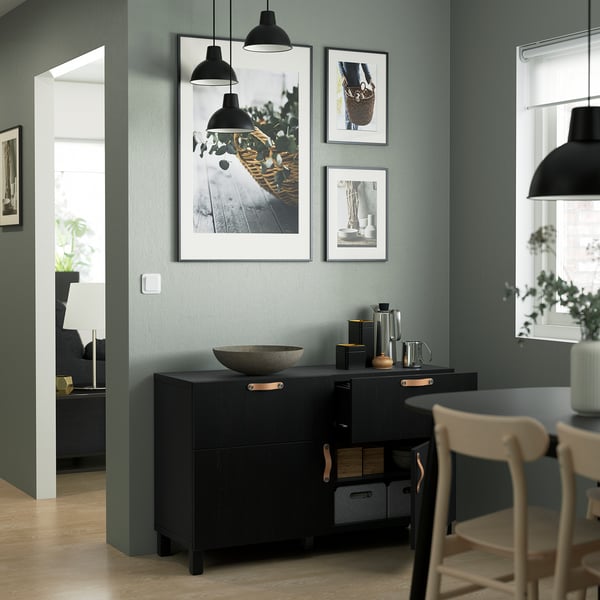 Modern kitchen a BESTÅ sideboard with adjustable shelves, soft-closing drawers, and ample storage. Above it, three framed photos hang on a green wall.