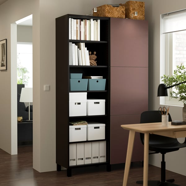 Black BESTÅ storage unit with shelves for boxes & books, taller than desk, modern & stylish.