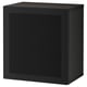 A black ikea BESTÅ storage unit. Its rectangular, made of particleboard and steel, with a perforated door.