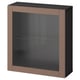 An IKEA BESTÅ cabinet in dark brown, featuring glass doors and a sleek, modern design.