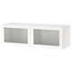 A white ikea BESTÅ wall unit with glass doors.