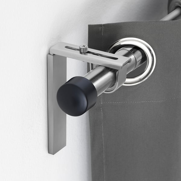 BETYDLIG silver curtain rod holder mounts on wall or ceiling. Adjustable, fits multiple curtain rod sizes. Small, sleek design.