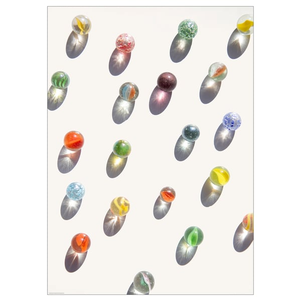 Colourful marbles inside transparent ovoids on white background; artistic print.