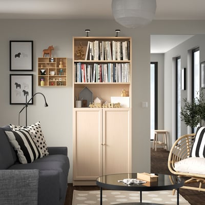 Cosy living room with BILLY bookcase and dark sofa.