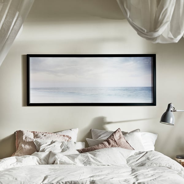 Large-print art frame BJÖRKSTA, white, minimalist bedroom decor.