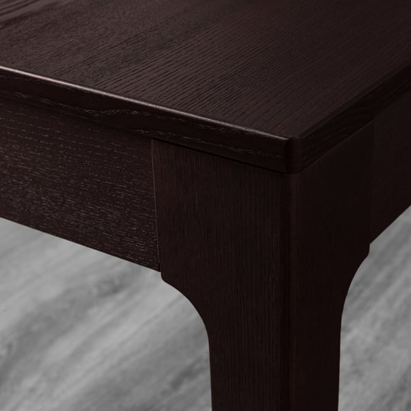 Dark wooden furniture piece, showcasing smooth, finely crafted edges and a polished finish. Reflects high-quality craftsmanship.