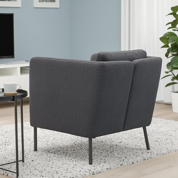 Modern armchairs, side table, plant - cosy blue room.