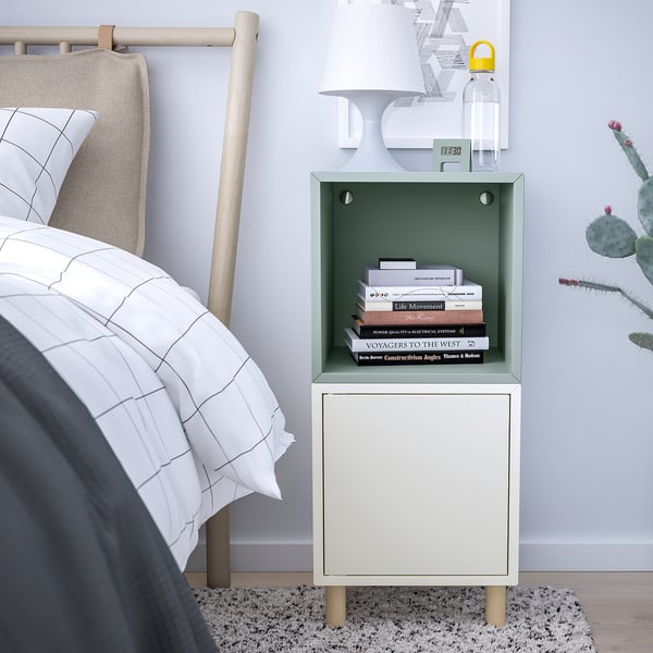 White & green EKET bedside table by bed with books & cabinet.