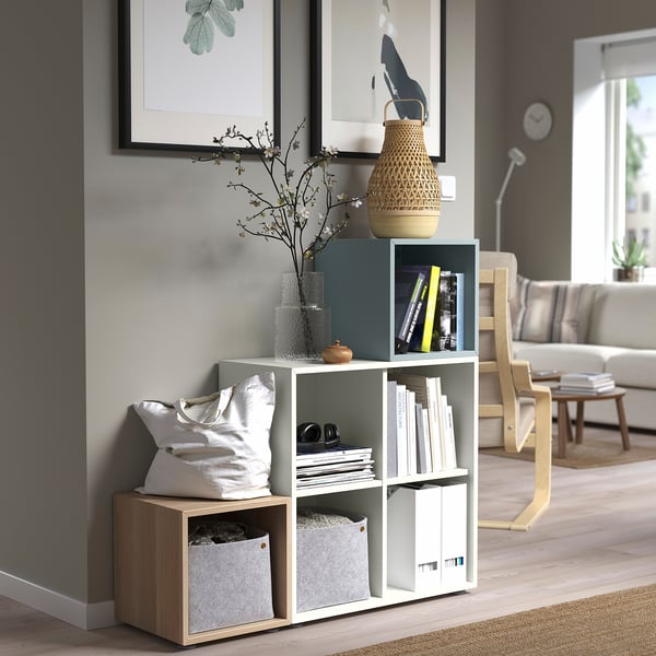 EKET cube storage in living room with books, flowers, and baskets.
