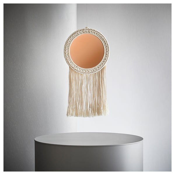 Unique circular woven wall hanging with mirror centre and long fringes, adding warmth and style.
