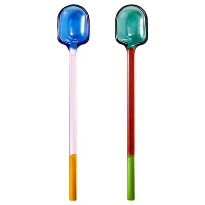 Two multi-colored glass spoons with rounded edges and varying handle colours, setting a playful table.