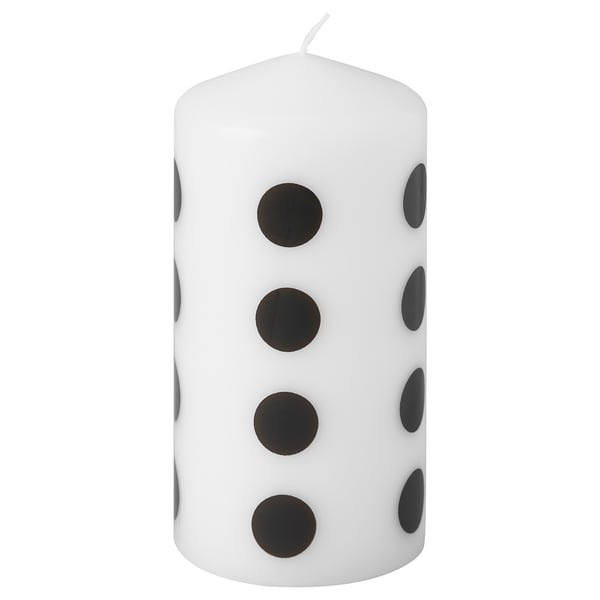 FENOMEN white candle with black dots, cylindrical shape.