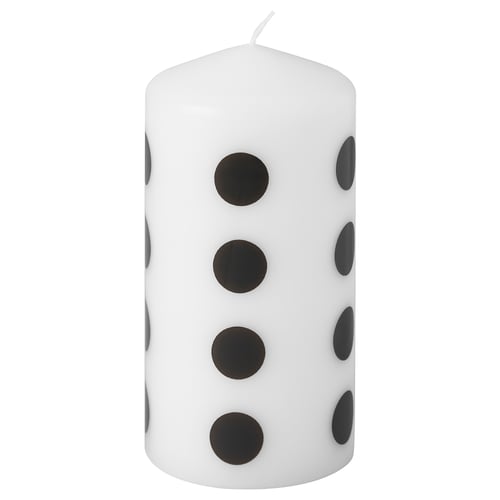 FENOMEN white candle with black dots, cylindrical shape.
