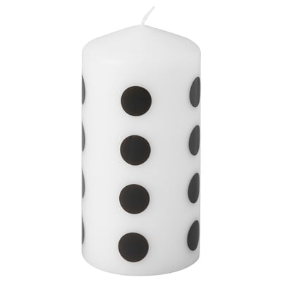 FENOMEN white candle with black dots, cylindrical shape.