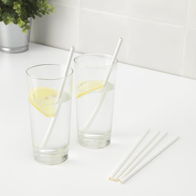 Two glasses with lemon slices and three white paper straws, set on a white surface.