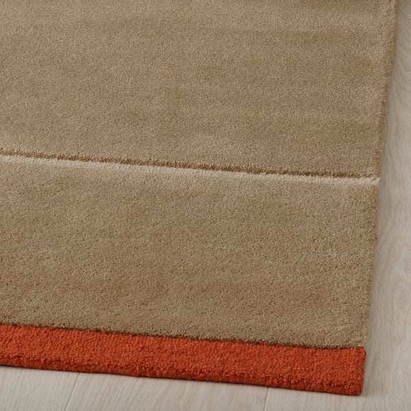 Close-up of handmade wool rug, showing soft texture and quality craftsmanship.
