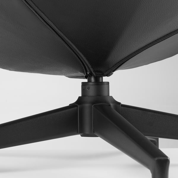Black leather footstool base detail, sturdy metal legs, premium materials.