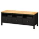 A black and light wood HEMNES tv bench. It three drawers, open storage, and solid pine construction.