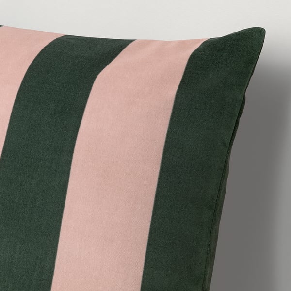 Soft pillow with green and pink stripes on plush velvet, showcasing quality craftsmanship.