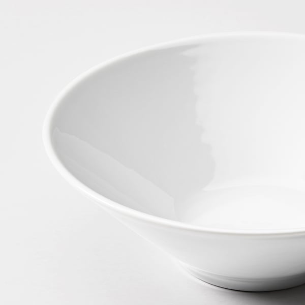 Clean, white plate with smooth, glossy surface and rounded edges. High-quality porcelain, reflecting light, sitting on a flat surface.