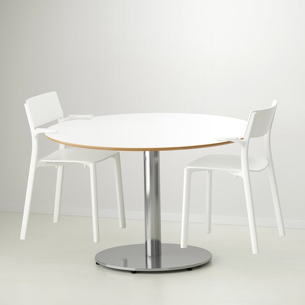 A modern, round dining table with two white plastic chairs, designed for home and restaurant use. Chairs are stackable and ready-to-assemble.