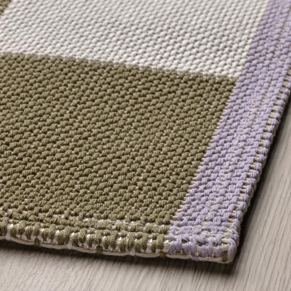 Flat-woven checkerboard rug with soft, textured surface. Contrasting edges, ideal for modern interiors.