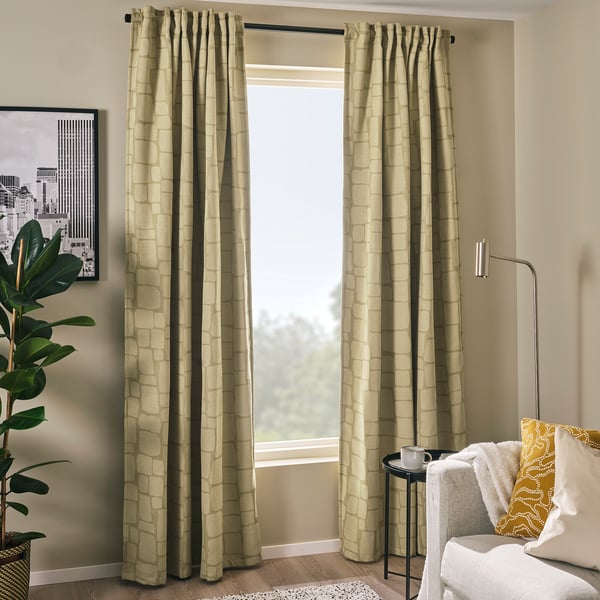 Olive green LÖNNSTÄVMAL curtains with block-out lining and subtle pattern.