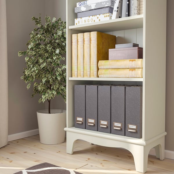 Bookshelf with 1 fixed shelf and 3 movable shelves, storing books and game boxes. A potted plant beside it.